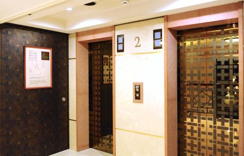 a hallway with two elevators in a building at Hotel Resol Sapporo Nakajima Koen in Sapporo
