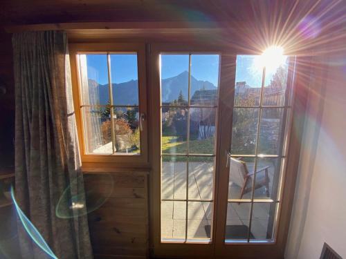a window with a view of a mountain at Haus Maran in Urmein