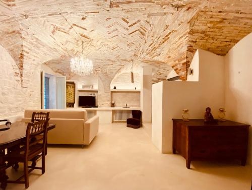 a living room with a couch and a table at Vermaaten Boutique Suites Ruby in Todi