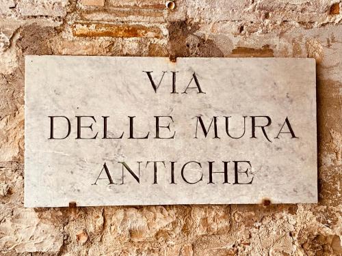 a sign on a brick wall that readsvia delle mire antille at Vermaaten Boutique Suites Ruby in Todi