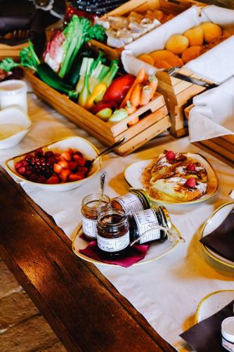 a table with plates of food and other foods on it at AGRITURISMO CA' FENILE in Alzano Lombardo