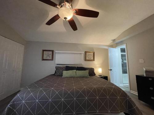 a bedroom with a bed with a ceiling fan at Suite 4 - Private Apartment Historical Home in Macon