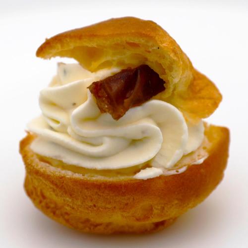 a piece of bread with cream cheese and meat in it at Guggital Hotel Restaurant in Zug