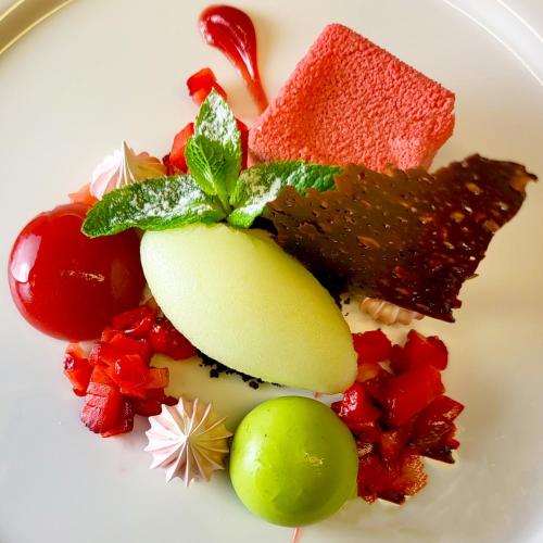 a plate of food with fruit and other foods at Guggital Hotel Restaurant in Zug