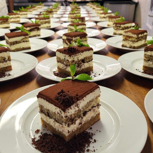 a row of cakes on plates on a table at Guggital Hotel Restaurant in Zug