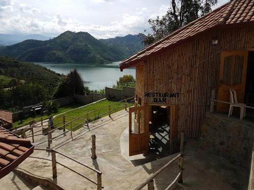 a building with a view of a lake and a mountain at Kivu Macheo eco-lodge in Kibuye