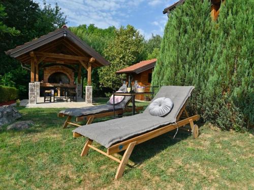 a couple of lounge chairs in a yard with a gazebo at Lavanda Land - Villa Tanya Mrežnica in Donji Zvečaj