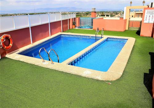 a swimming pool on the roof of a building at Apartment Segura 2BD in Rojales