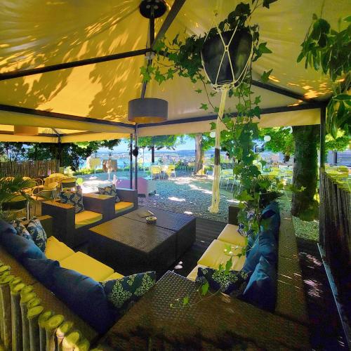 a large tent with couches and tables in a patio at Guggital Hotel Restaurant in Zug