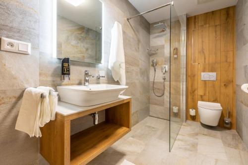 a bathroom with a sink and a shower at APLEND Lake Resort in Vysoke Tatry - Strbske Pleso