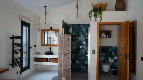 a bathroom with a shower and a sink and a mirror at Villa Isabella in Cómpeta