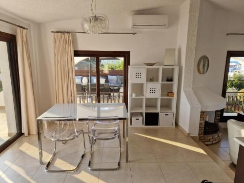 a kitchen with a white table and chairs in a room at The Belvedere Villa Latchi in Lachi