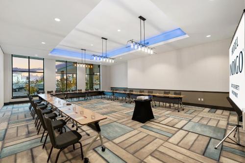 a conference room with tables and chairs and windows at Hotel Indigo Seattle Everett Waterfront Place by IHG in Everett