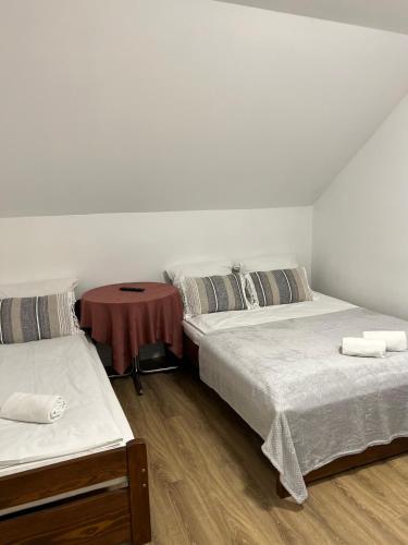 a room with two beds and a table in it at Motel S7 in Goszczyn