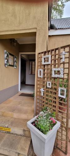 a house with a planter in front of a building at The Leopard Tree in Polokwane