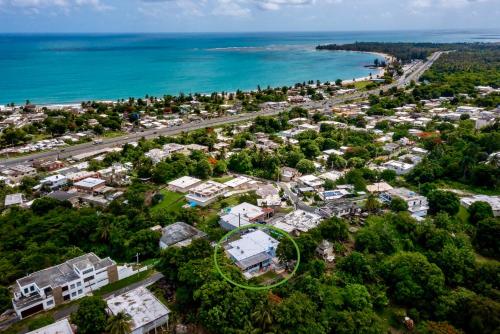an aerial view of a resort with the ocean at Lucky Luquillo Solar El Yunque & Beach Retreat - 360 Ocean & Rainforest Views in Fortuna