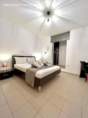 sypialnia z łóżkiem i wentylatorem sufitowym w obiekcie City Flats Apt.C307 w Larnace