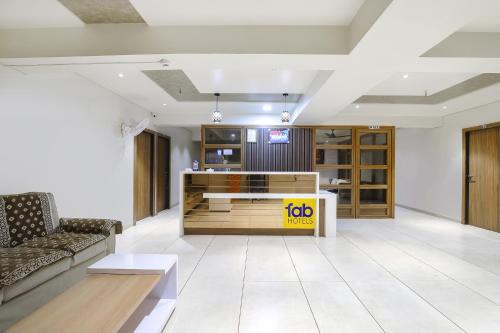 a living room with a couch and a counter at FabHotel Bharosa Inn in Ahmedabad