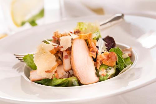 a salad on a white plate with a fork at Cabra Castle Hotel in Kingscourt