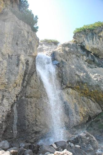 a waterfall on the side of a rocky cliff at Apart Pitzenklamm in Arzl im Pitztal