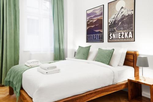 1 dormitorio con 1 cama blanca grande con cortinas verdes en HOUSEHOST Apartment :Starowiślna 66/9 Street en Cracovia