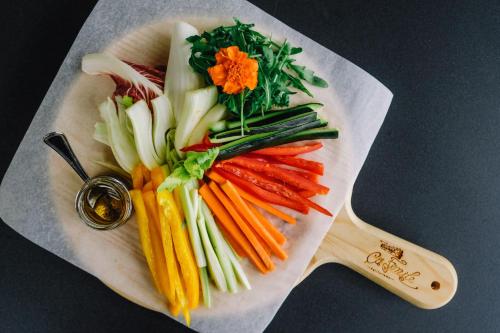 a pile of vegetables on a plate with a spoon at AGRITURISMO CA' FENILE in Alzano Lombardo