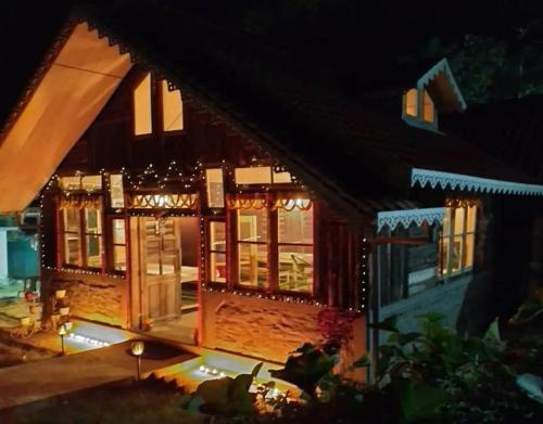 a house lit up at night with lights at Dharti - The Glamping Haven by StayApart in Bijanbāri Bāzār