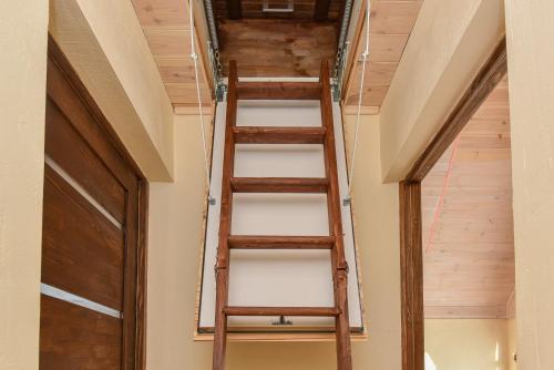 a ladder leading up to the loft in a house at Kopų ramybė in Palanga