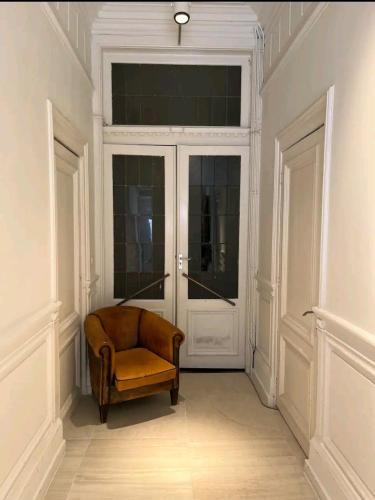 una stanza con una sedia davanti ad una porta di De Cosy Barock met gezellige Patio ! a Breda