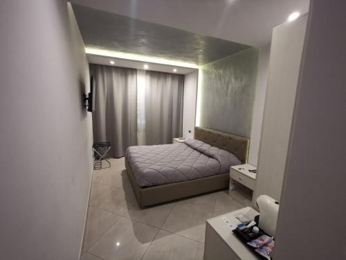 a small bedroom with a bed and a mirror at B&B Rossini Luxury in Rende