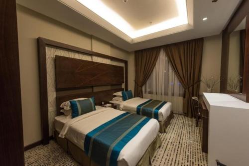 a hotel room with two beds and a sink at Voyage Hotel & Suites in Riyadh