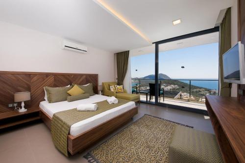 a bedroom with a large bed and a large window at Villa Pırlanta, Kalkanvilla in Kalkan