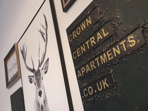 a sign with a picture of a deer on a wall at Crown Central Apartments in Aberdeen