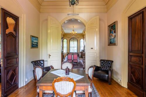 a dining room with a table and chairs at Büyükada Anastasia Meziki History Mansion in Buyukada