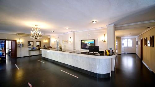 a large lobby with a bar in the middle at Playa Real in Marbella