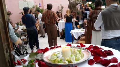 a group of people standing around a table with a candle at Büyükada Anastasia Meziki History Mansion in Buyukada
