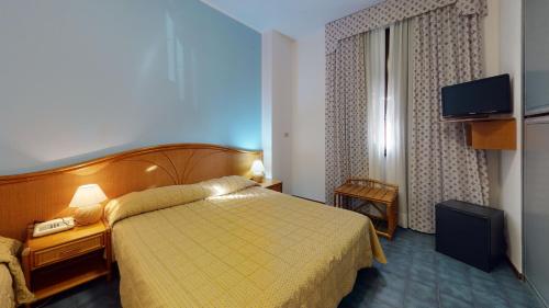 Postel nebo postele na pokoji v ubytování Hotel Zunino