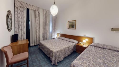 Postel nebo postele na pokoji v ubytování Hotel Zunino