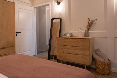 a bedroom with a bed and a dresser and a mirror at Luxury 2BDR in the Heart of Valletta! TV and WiFi in Valletta