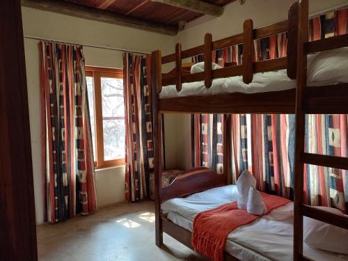 a bedroom with two bunk beds in a house at Okutala Etosha Lodge in Outjo