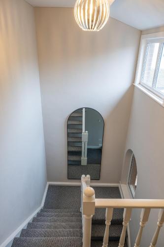 a stairway with a mirror and a cross on it at Escape Ordinary in Enniskillen in Enniskillen