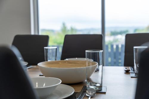 a wooden table with a bowl on top of it at Escape Ordinary in Enniskillen in Enniskillen