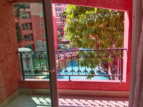 an open door to a balcony with a swimming pool at Seven Seas Condo Resort Jomtien in Jomtien Beach