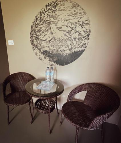 a table with two chairs and a globe on the wall at New Hotel Castle in Pokhara