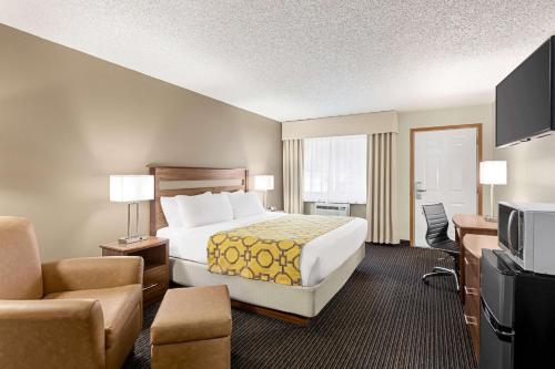 a hotel room with a bed and a television at Baymont by Wyndham Whitefish in Whitefish