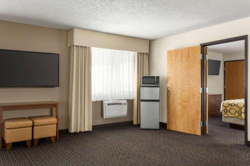 a hotel room with a bed and a television at Baymont by Wyndham Whitefish in Whitefish