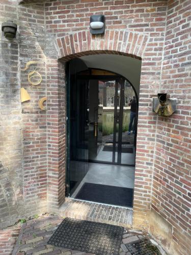 an entrance to a brick building with an open door at LOFT 188 Luxury Apartment Hotel in Utrecht