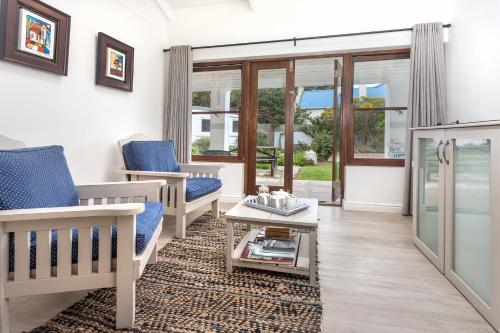 a living room with two chairs and a coffee table at Sixteen Guesthouse on Main in Hermanus