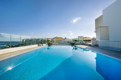 a large swimming pool on the roof of a building at Plaza Regency Hotels in Sliema