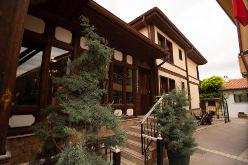 a house with two trees in front of it at Arasta Konak Otel in Eskisehir